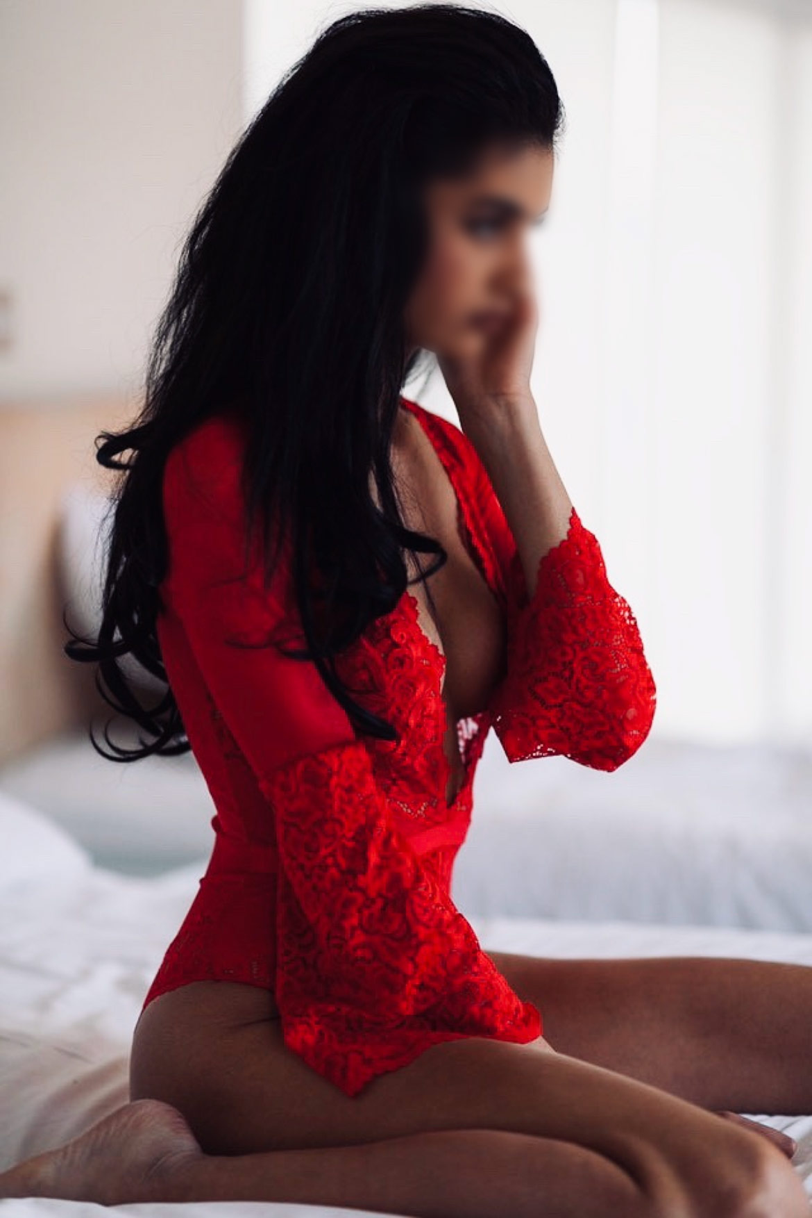 Woman in bed wearing red dress