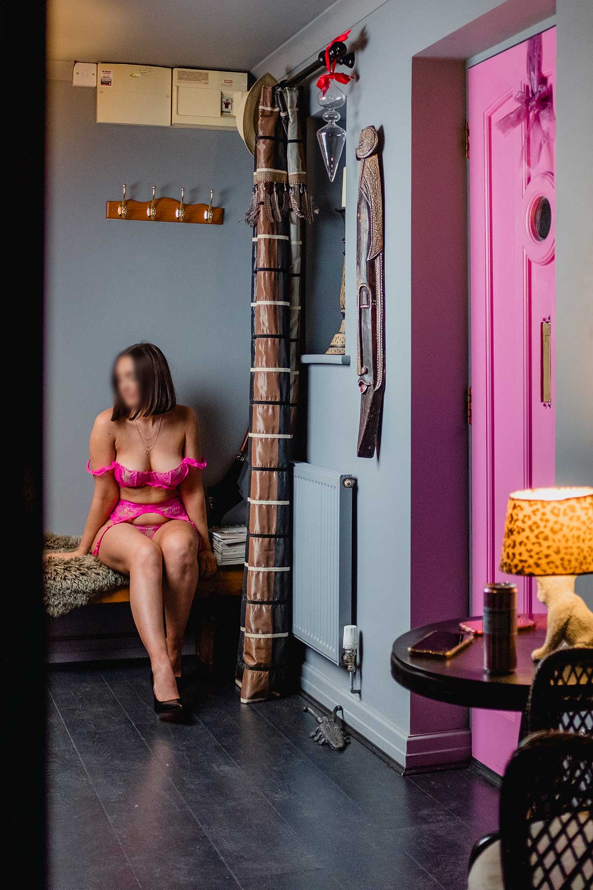 Nottingham escort sat in hallway in pink lingerie
